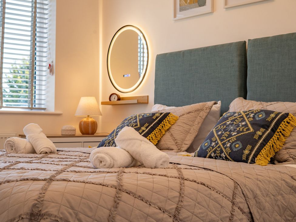 A bedroom with a bed and decorative pillows at 4 Bryn Heulog in Wrexham