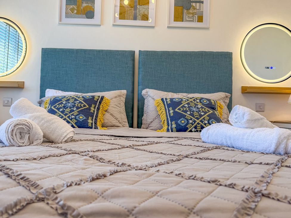 A bedroom with a bed and wall art at 4 Bryn Heulog in Wrexham