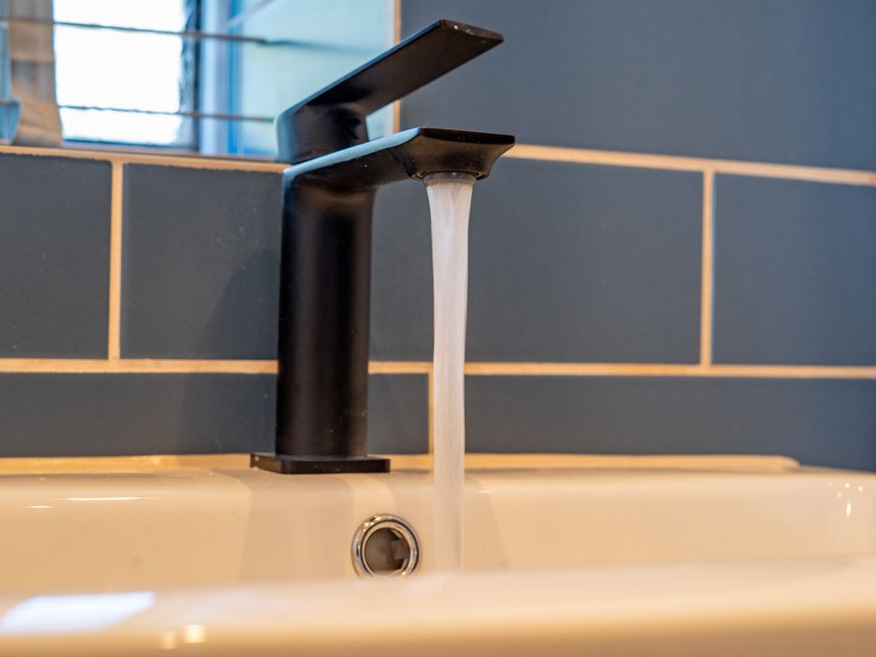A faucet with water flowing into a sink at 4 Bryn Heulog, Wrexham