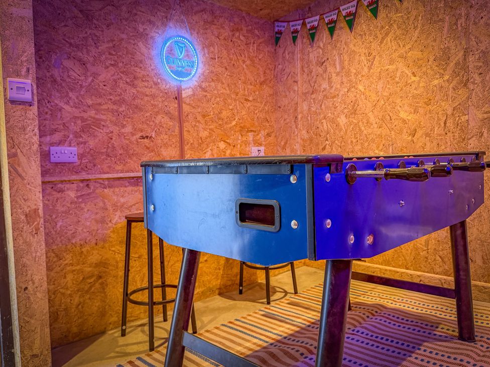 A game room with a foosball table and bar stool at 4 Bryn Heulog in Wrexham
