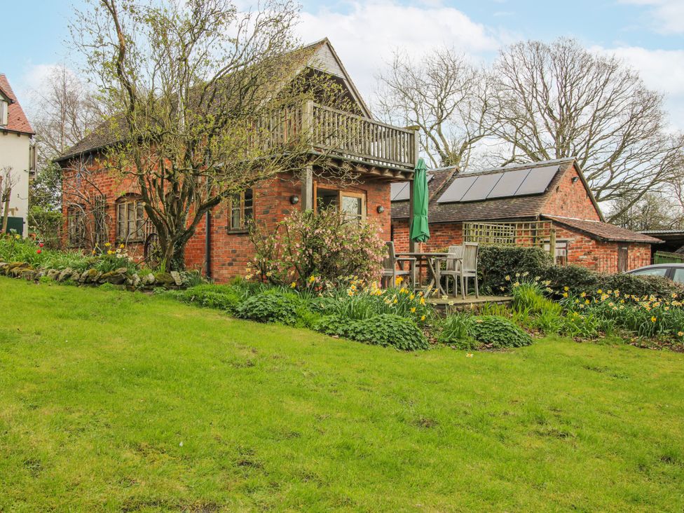A house with a balcony and garden at Bell House Cottage in Wistanstow near Craven Arms