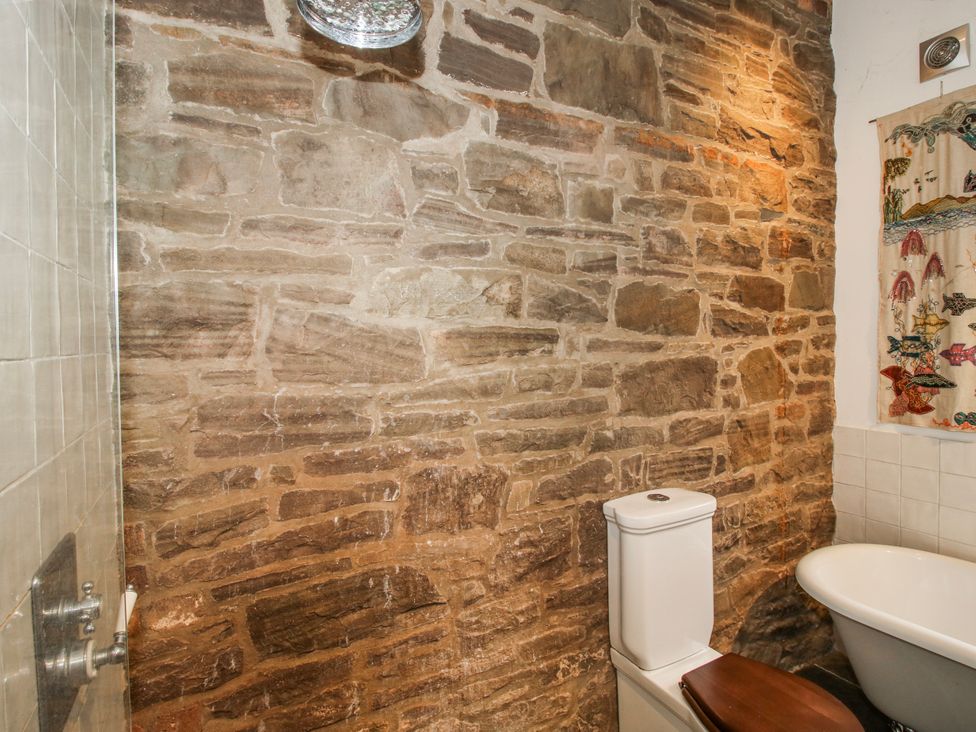 A bathroom featuring a toilet and sink at Bell House Cottage in Wistanstow near Craven Arms