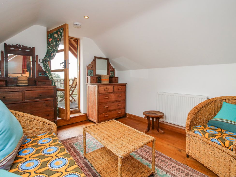 A seating area with furniture in an attic at Bell House Cottage in Wistanstow near Craven Arms