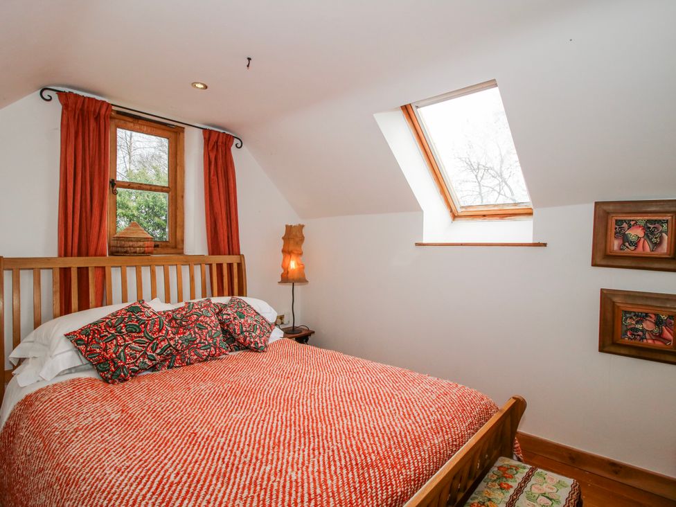 A bedroom with a bed and a window at Bell House Cottage in Wistanstow near Craven Arms