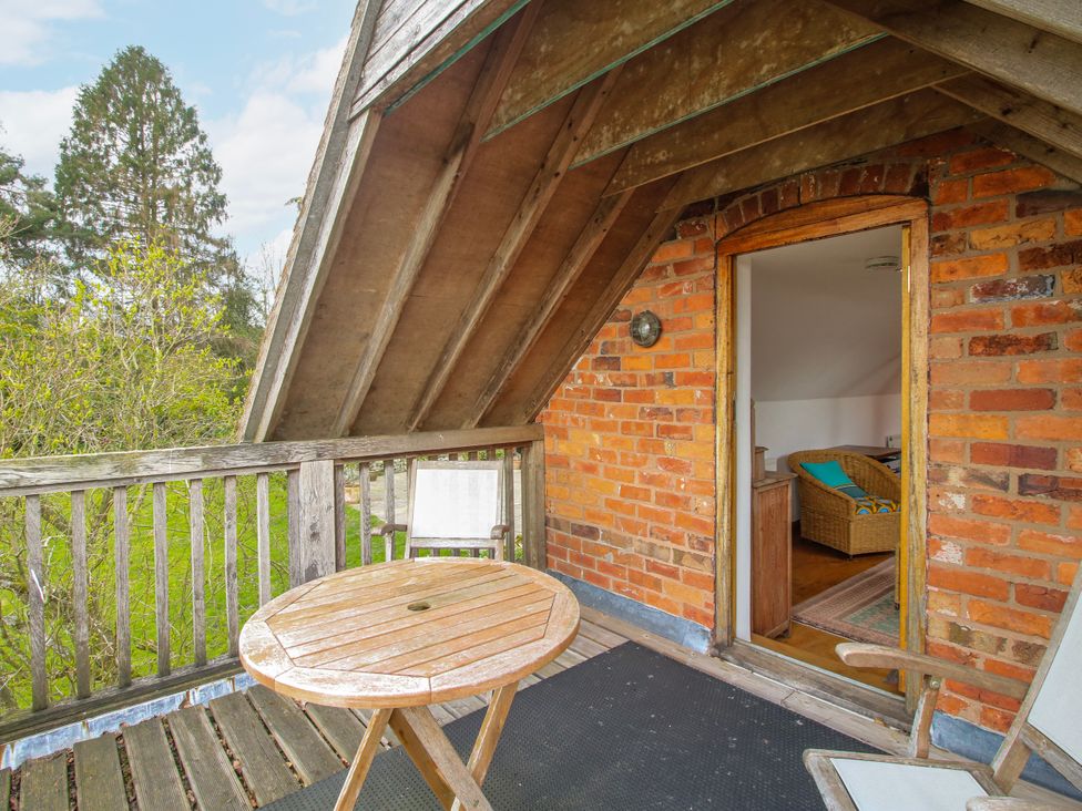 A balcony with a table and chairs at Bell House Cottage Wistanstow near Craven Arms