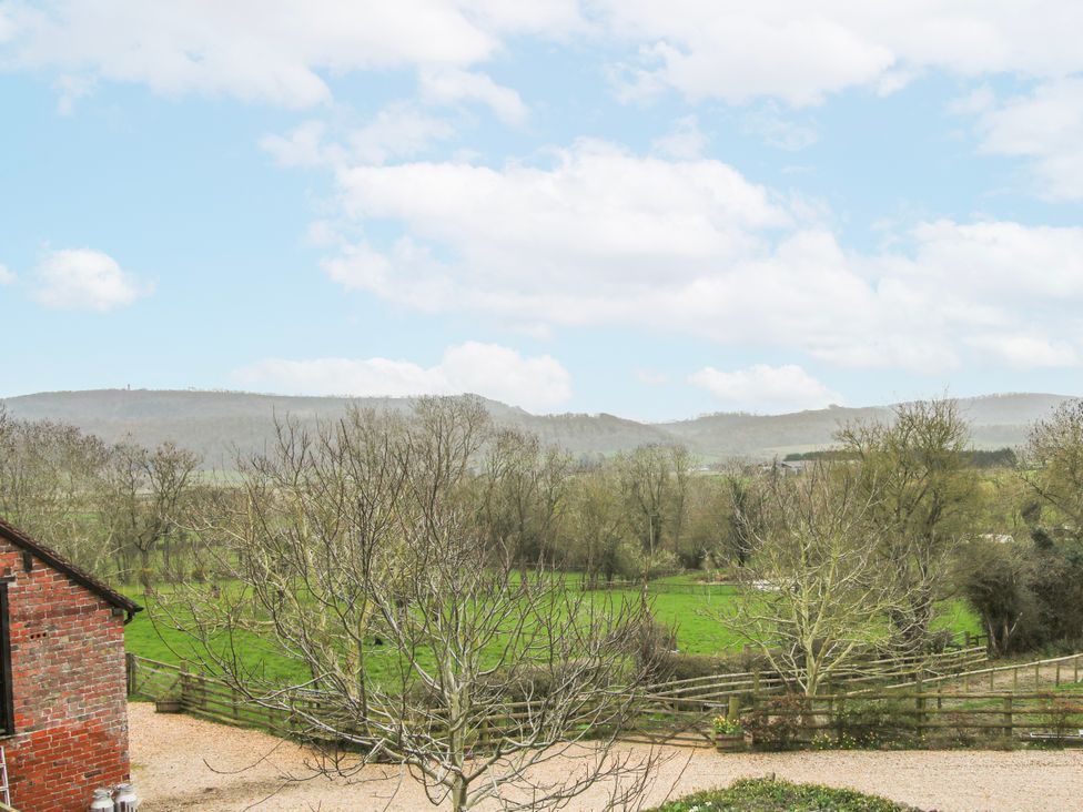 A view of a grassy field and mountains at Bell House Cottage Wistanstow near Craven Arms