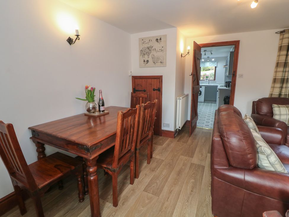 A dining room with a wooden table and chairs at Wayside Cottage at Wayside Farm Matlock
