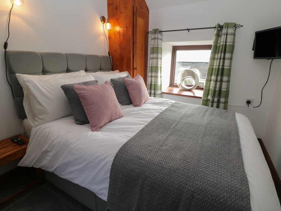 A bedroom with a bed and window at Wayside Cottage at Wayside Farm Matlock