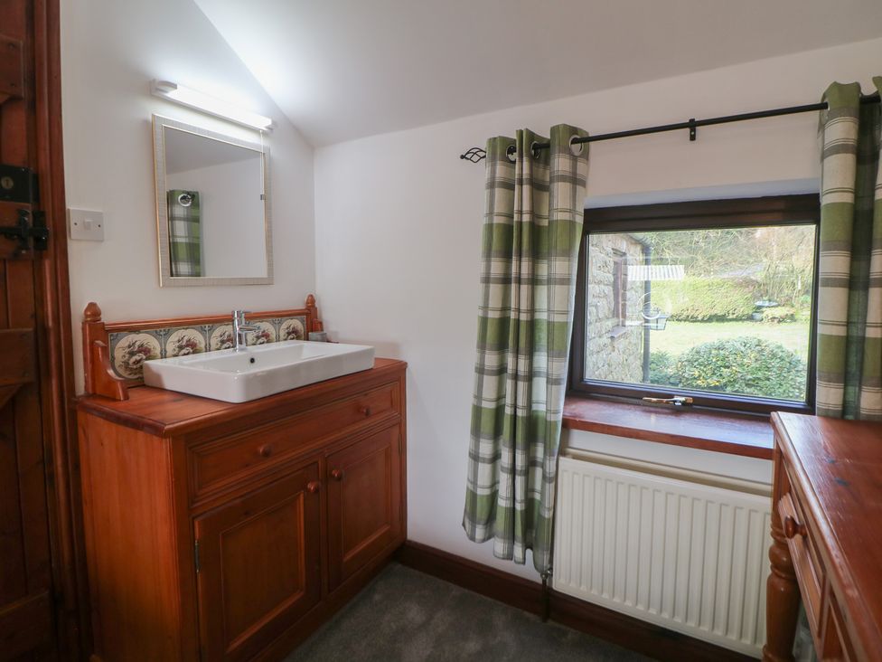 A bathroom with a sink and mirror at Wayside Cottage at Wayside Farm Matlock
