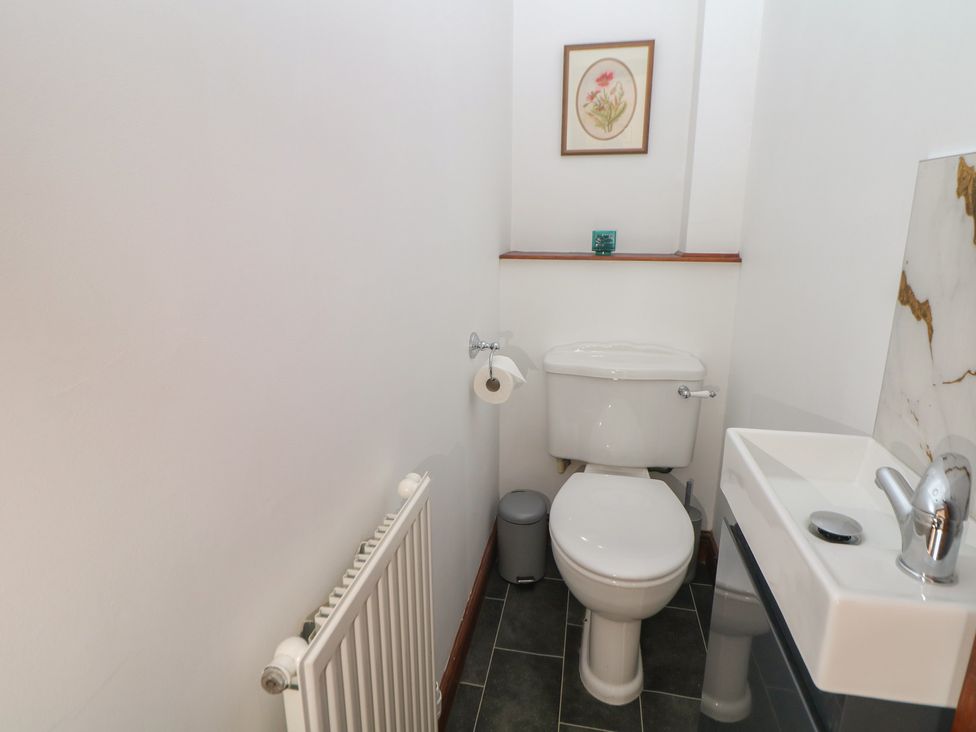A bathroom with a toilet and sink at Wayside Cottage at Wayside Farm Matlock