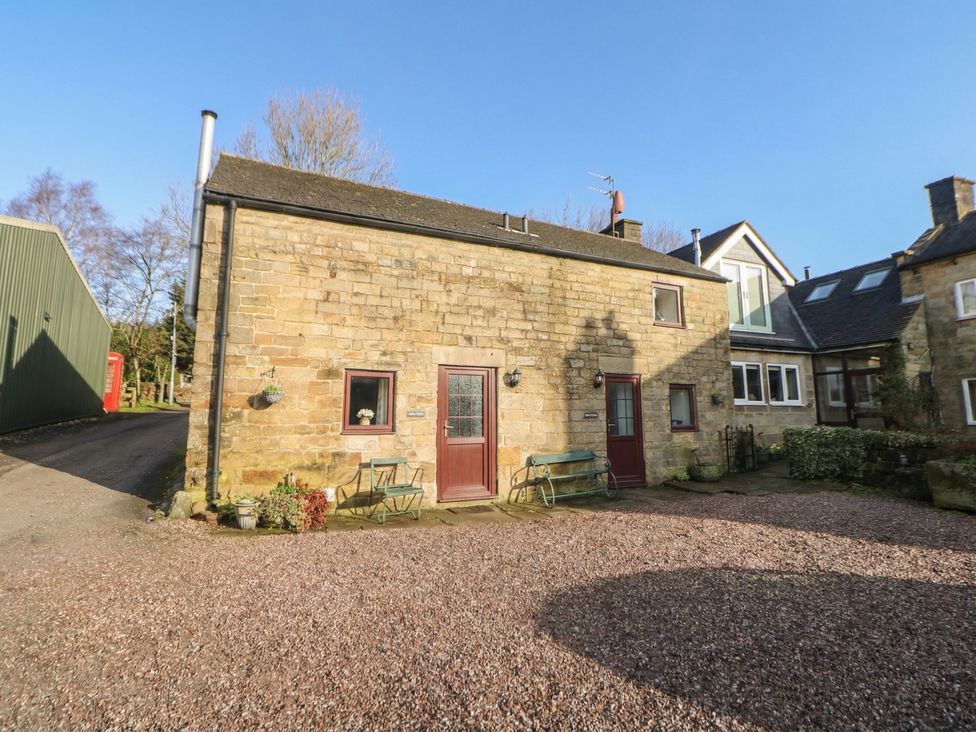A stone cottage with a gravel driveway at Wayside Cottage at Wayside Farm in Matlock