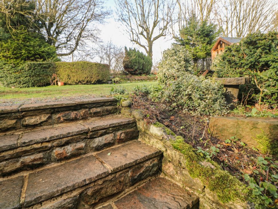 A pathway with steps in a garden at Wayside Cottage at Wayside Farm Matlock