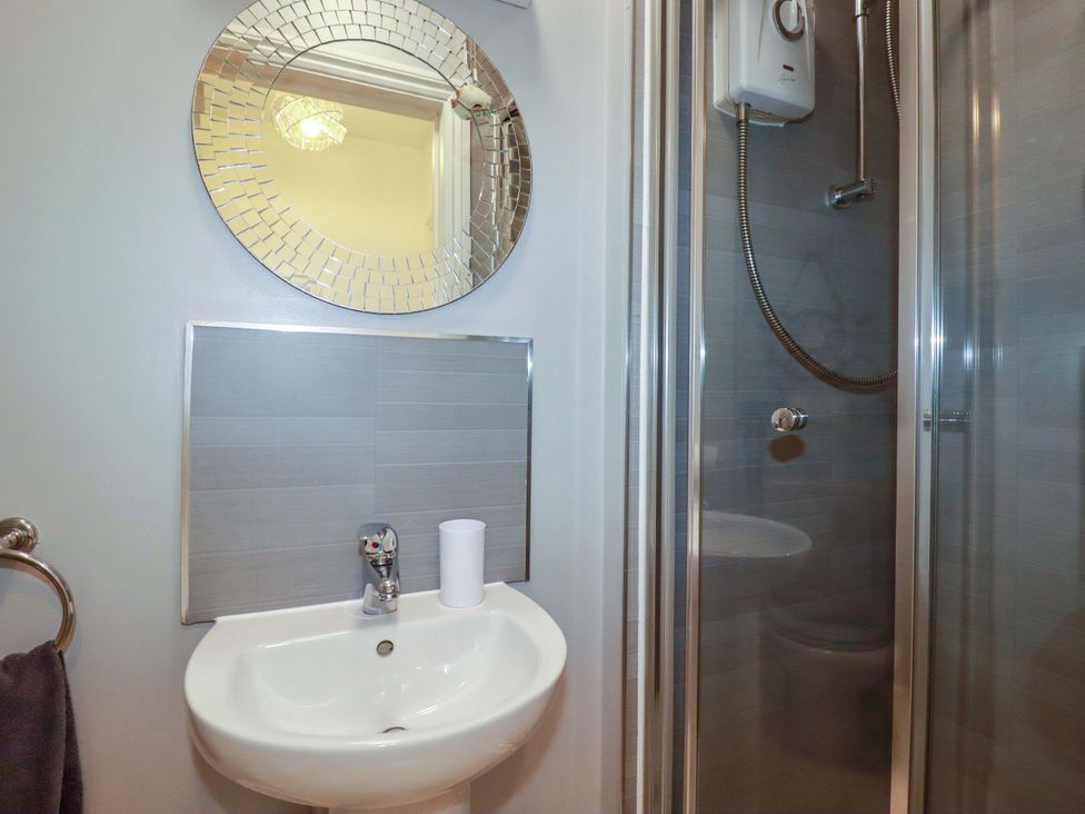 A bathroom with a sink and shower at Tolcarne Reach in Newquay
