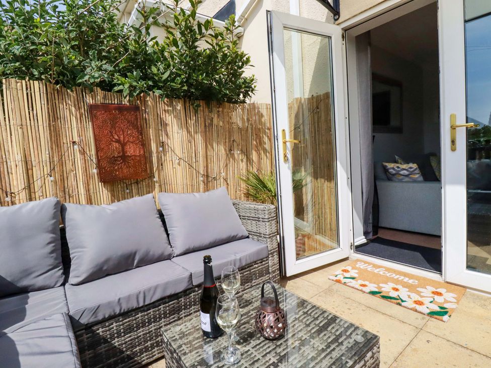 An outdoor seating area with a couch and table at Tolcarne Reach in Newquay