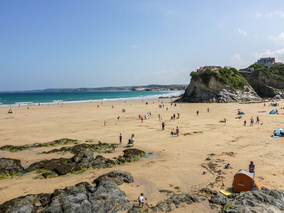 A beach with people and tents at Tolcarne Reach in Newquay
