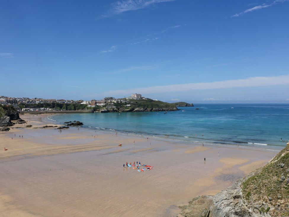 A beach with people and blue ocean at Tolcarne Reach in Newquay