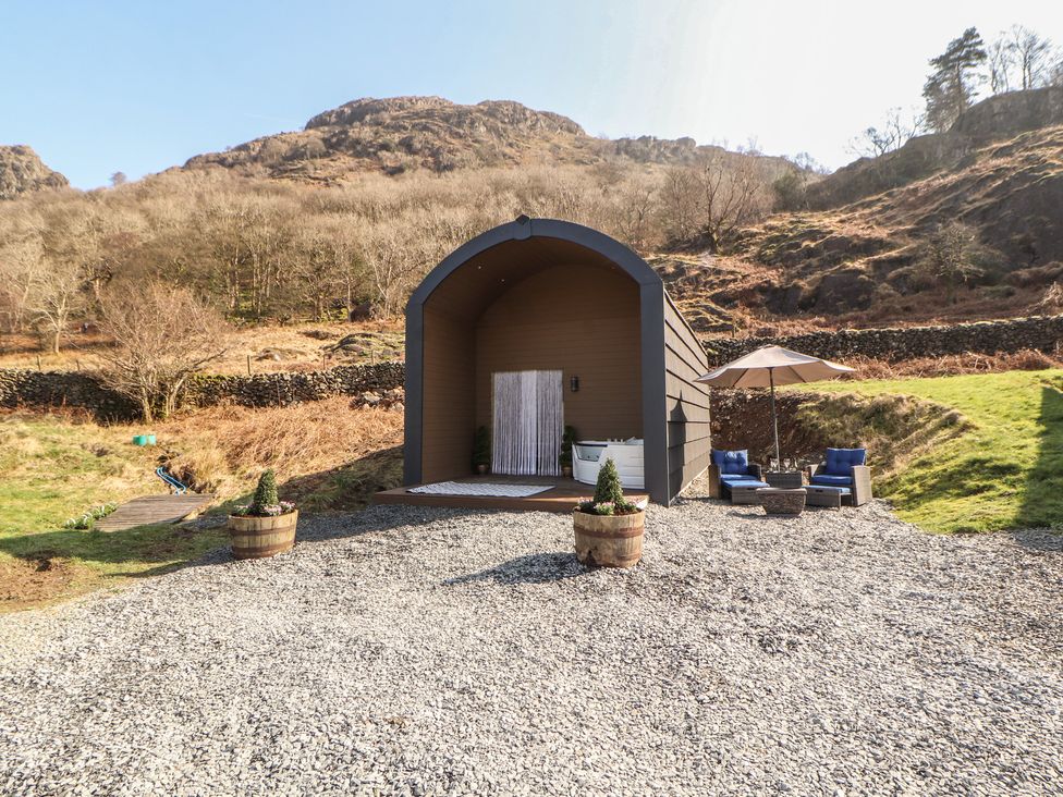 An outdoor area with a glamping pod and seating at Bluebelle - Crossgate Luxury Glamping Hartsop
