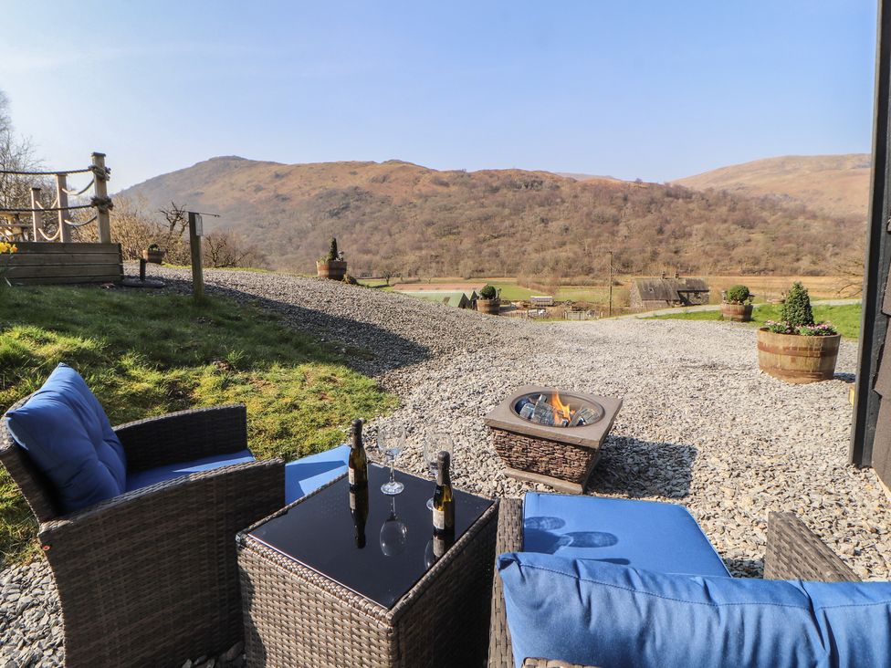 An outdoor area with chairs and a fire pit at Bluebelle - Crossgate Luxury Glamping Hartsop