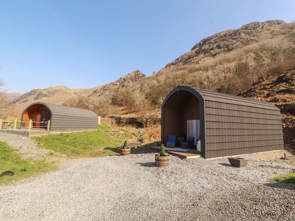 Two glamping pods with green grass and gravel path at Bluebelle - Crossgate Luxury Glamping Hartsop