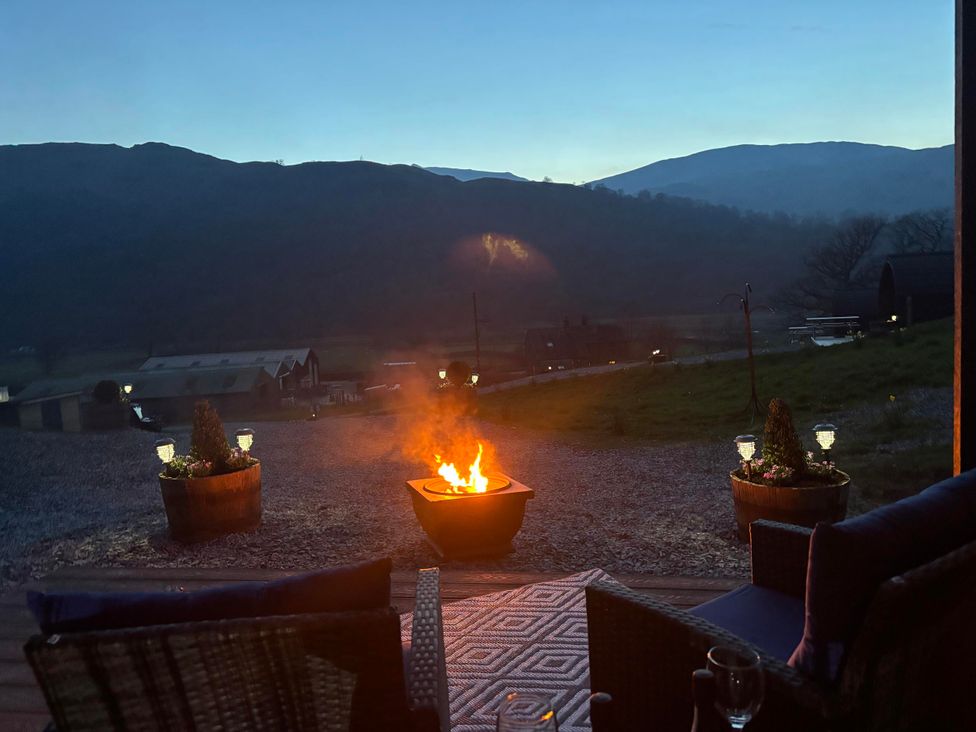 An outdoor area with a fire pit and seating at Bluebelle - Crossgate Luxury Glamping in Hartsop