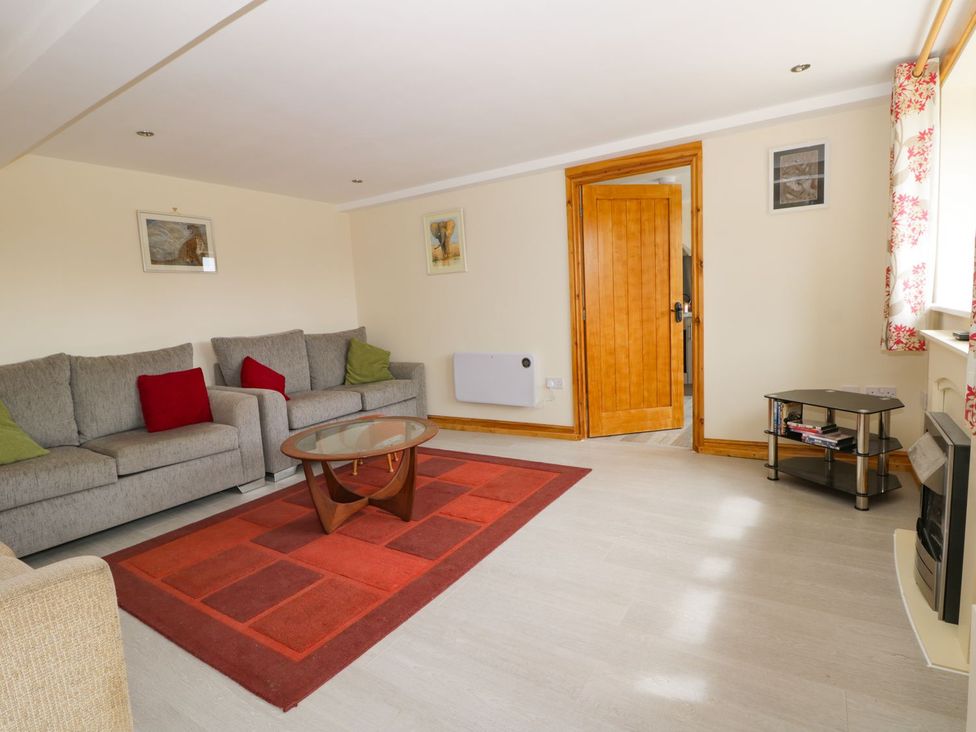 A living room with a sofa and coffee table at Lavender Lodge in Hull