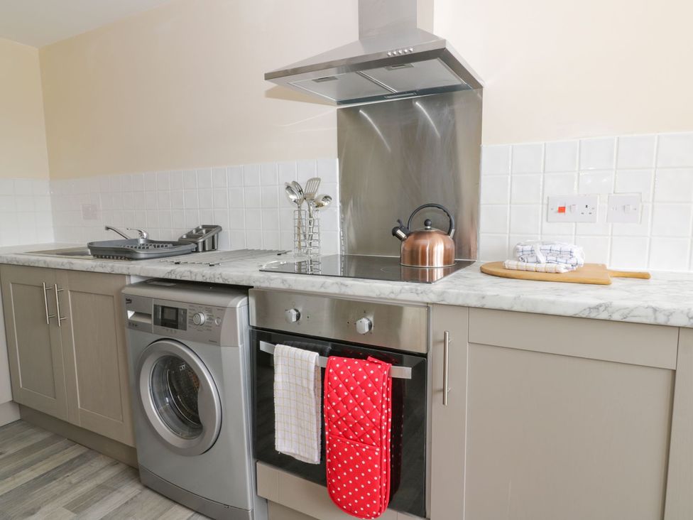 A kitchen with appliances and utensils at Lavender Lodge in Hull