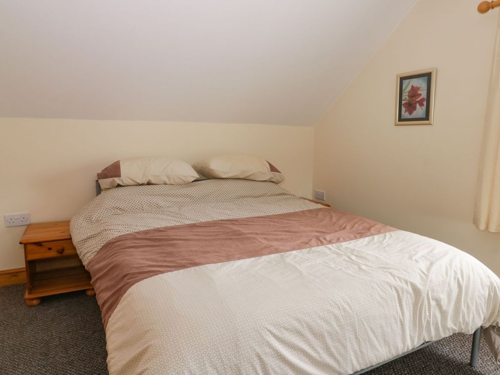 A bedroom with a bed and bedside table at Lavender Lodge in Hull