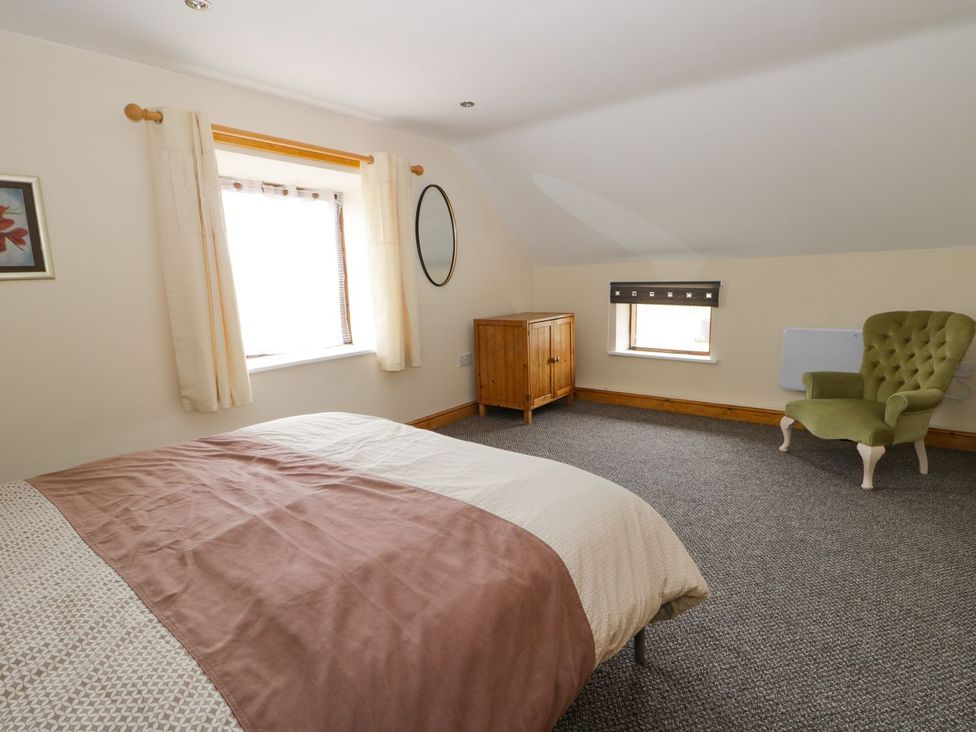 A bedroom with a bed and a cabinet at Lavender Lodge in Hull