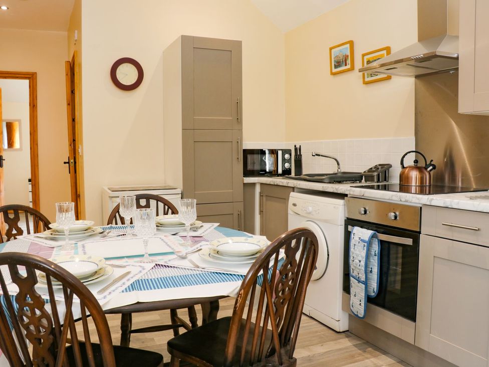 A kitchen with a dining table and appliances at Meadow View in Hull