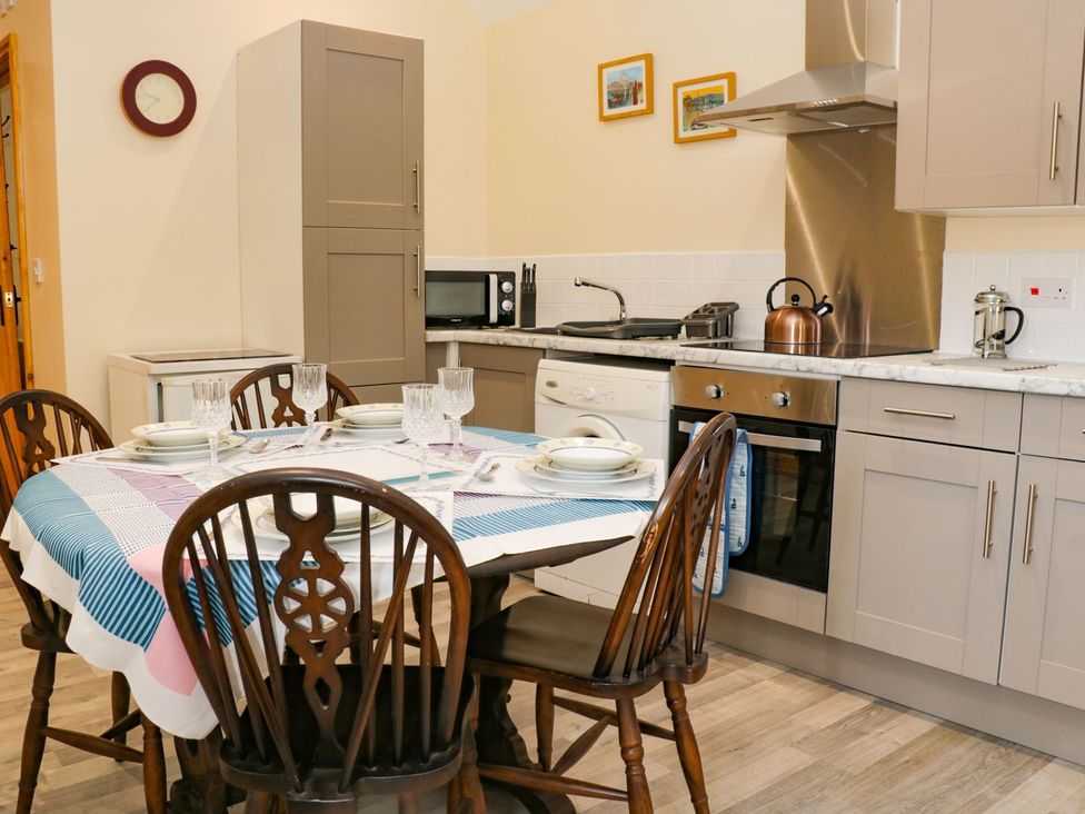 A kitchen with a dining table and chairs at Meadow View in Hull
