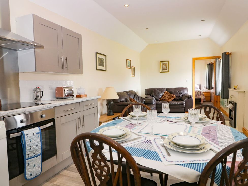 A dining room with a table and chairs at Meadow View in Hull