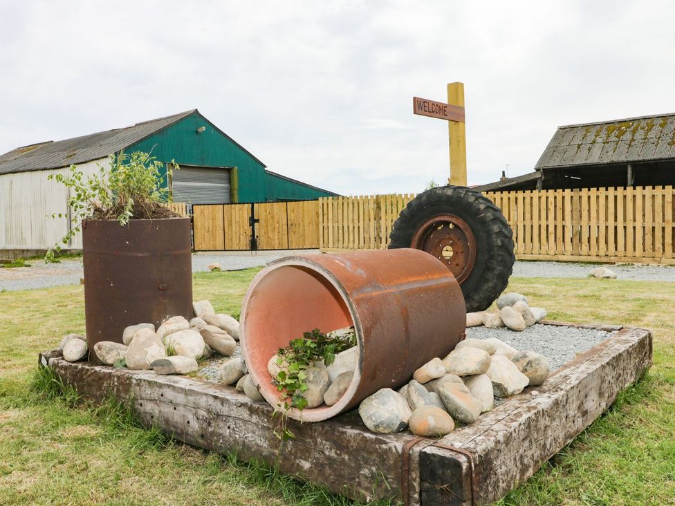 An outdoor decoration with a tire and metal barrel at Meadow View in Hull