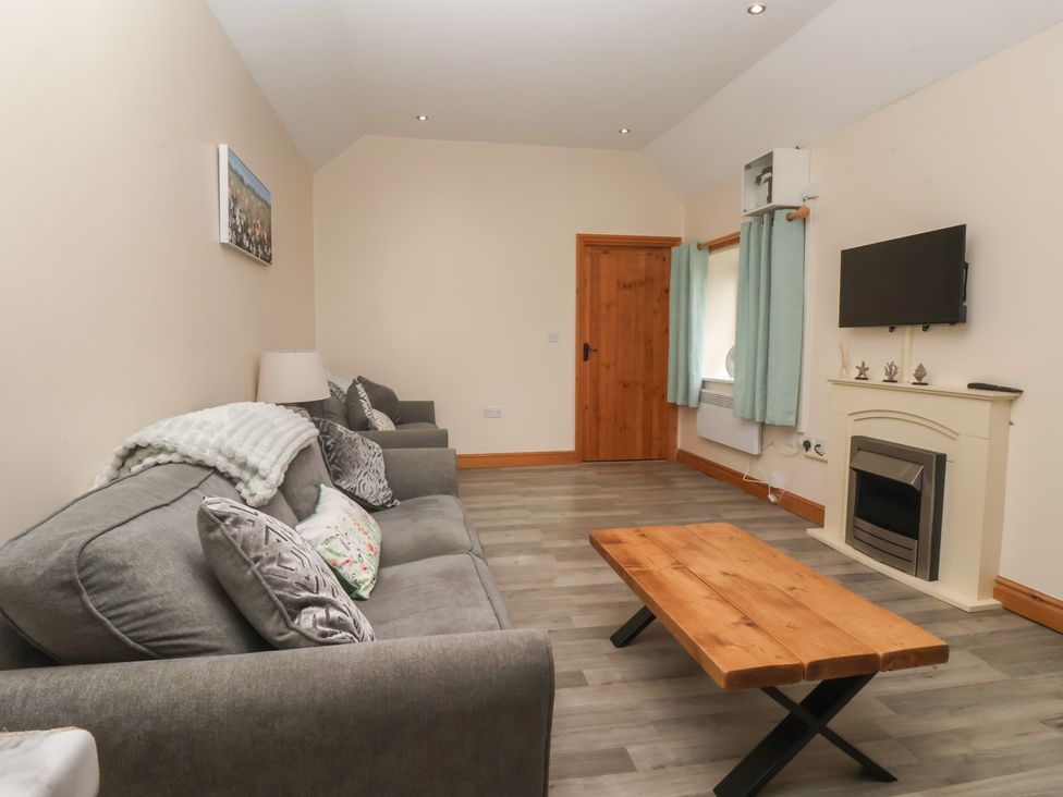 A living room with a sofa and a coffee table at Meadow View Tunstall near Withernsea