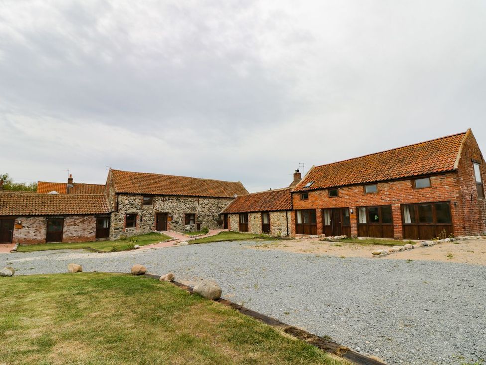 An outdoor area with stone and brick buildings at Mulberry Manor in Hull