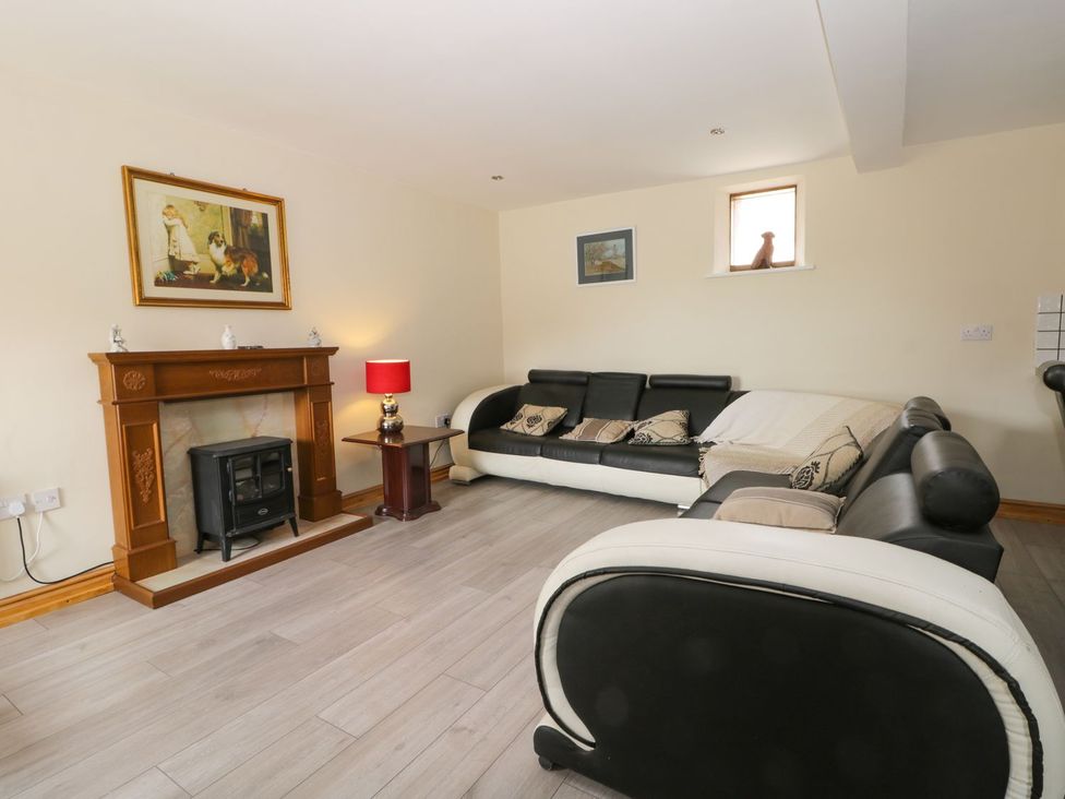 A living room with a sofa and fireplace at Mulberry Manor in Hull