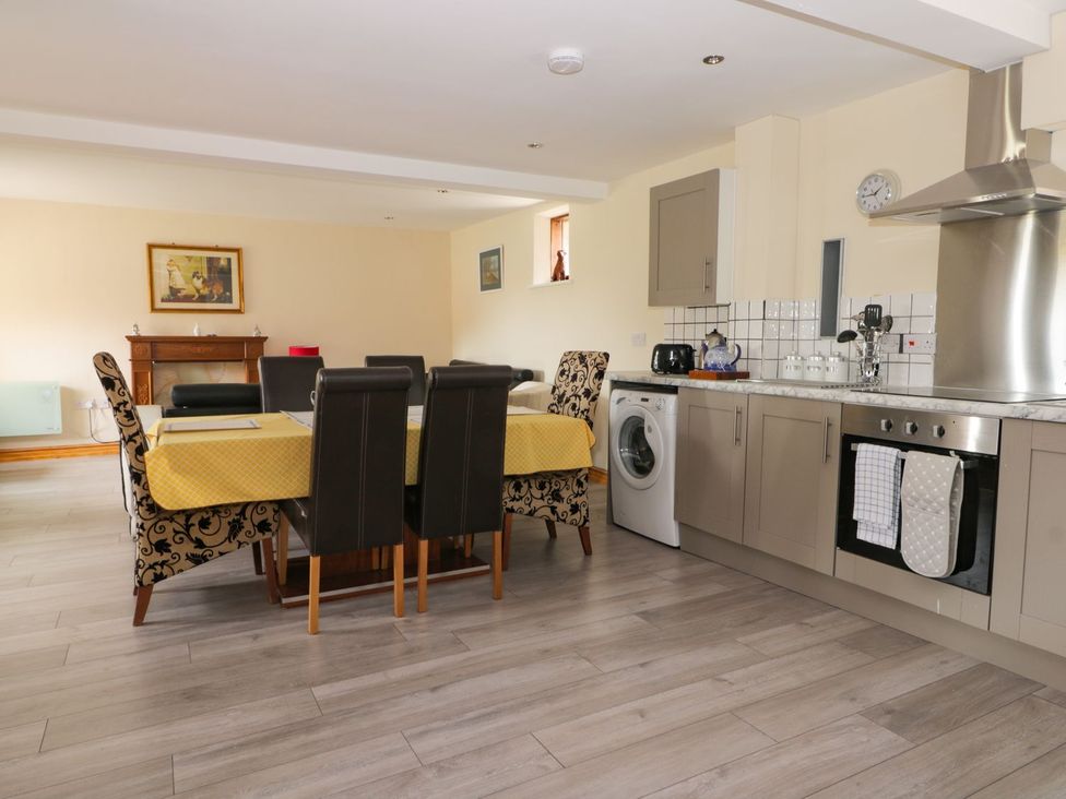 A kitchen with a dining table and chairs at Mulberry Manor in Hull