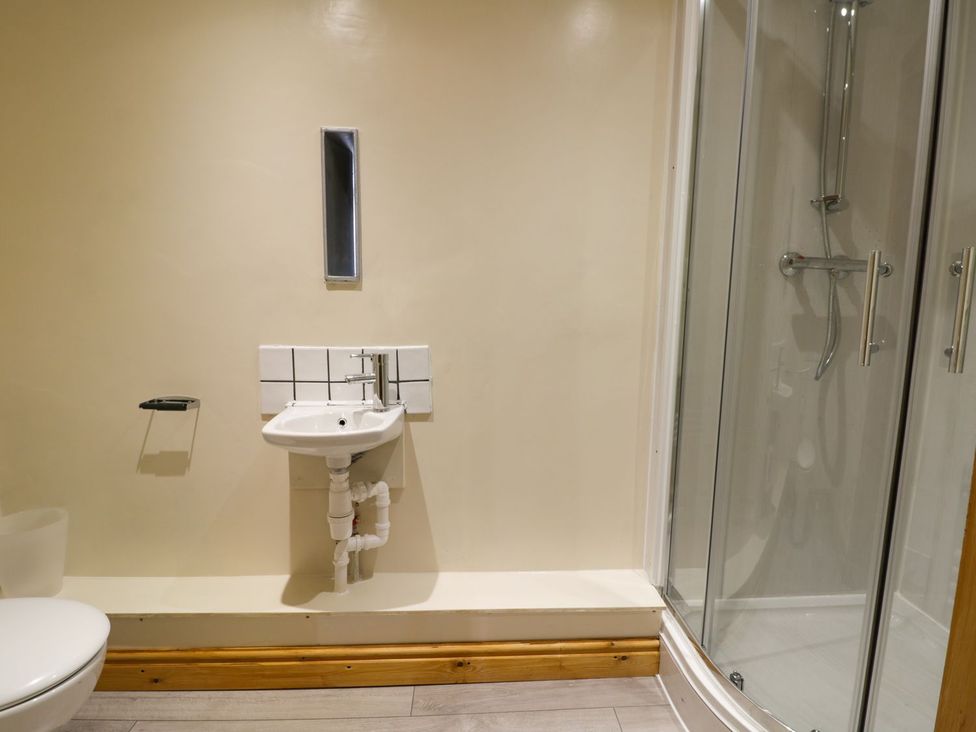 A bathroom with a toilet and a sink at Mulberry Manor in Hull
