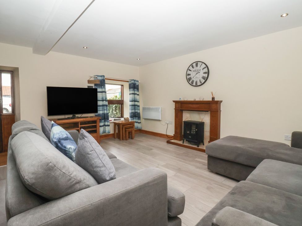 A living room with a sofa and television at Mulberry Manor Tunstall near Withernsea