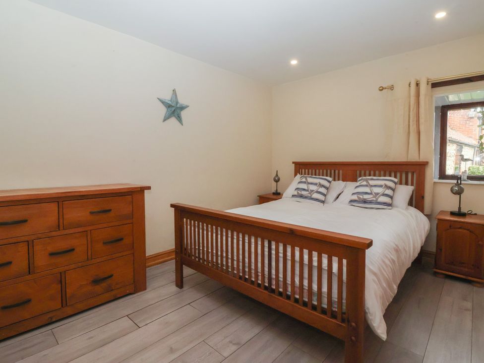 A bedroom with a bed and furniture at Mulberry Manor in Tunstall near Withernsea
