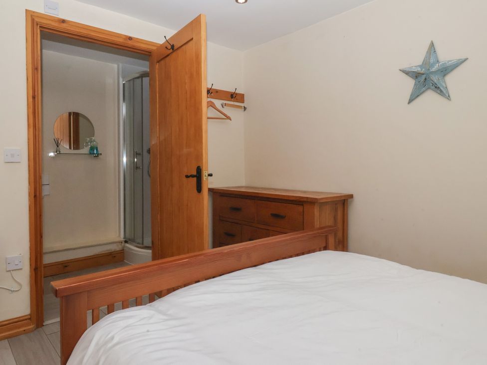 A bedroom with a bed and wooden dresser at Mulberry Manor near Tunstall
