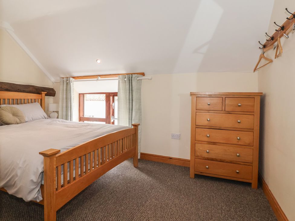 A bedroom with a bed and dresser at Mulberry Manor Tunstall near Withernsea