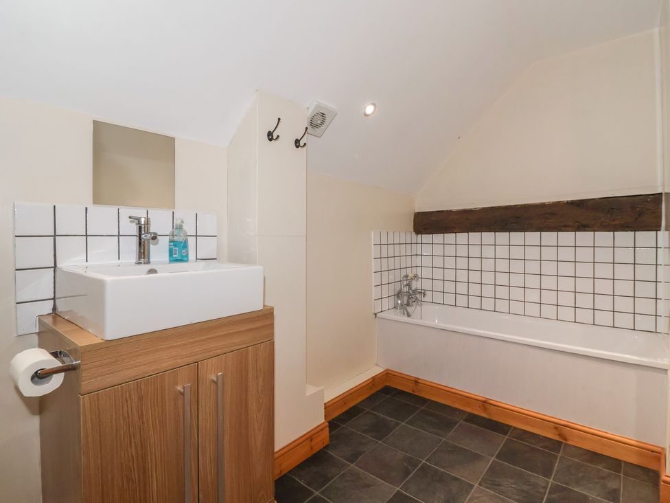 A bathroom with a sink and bathtub at Mulberry Manor in Tunstall near Withernsea