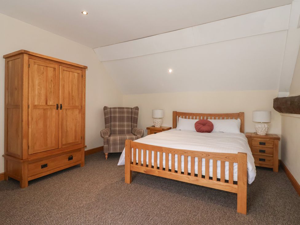 A bedroom with a bed and wardrobe at Mulberry Manor Tunstall near Withernsea