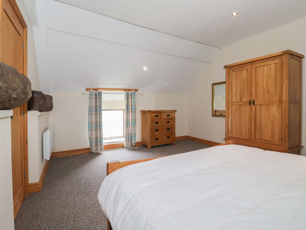 A bedroom with a bed, dressing table, and wardrobe at Mulberry Manor in Tunstall near Withernsea