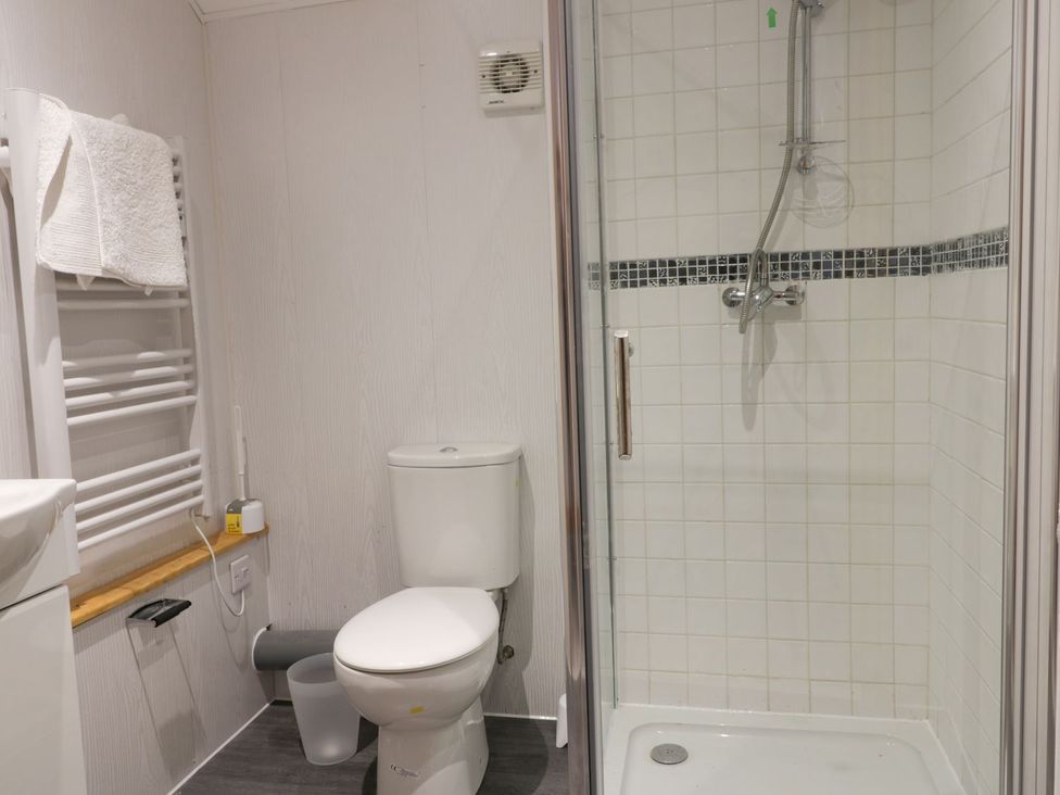 A bathroom with a shower and toilet at Honeybee Cottage in Hull