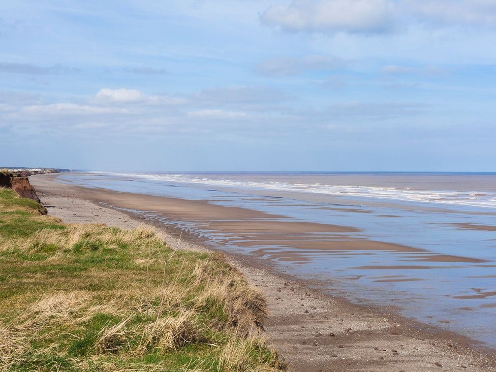 A beach with sand and water at Honeybee Cottage in Hull