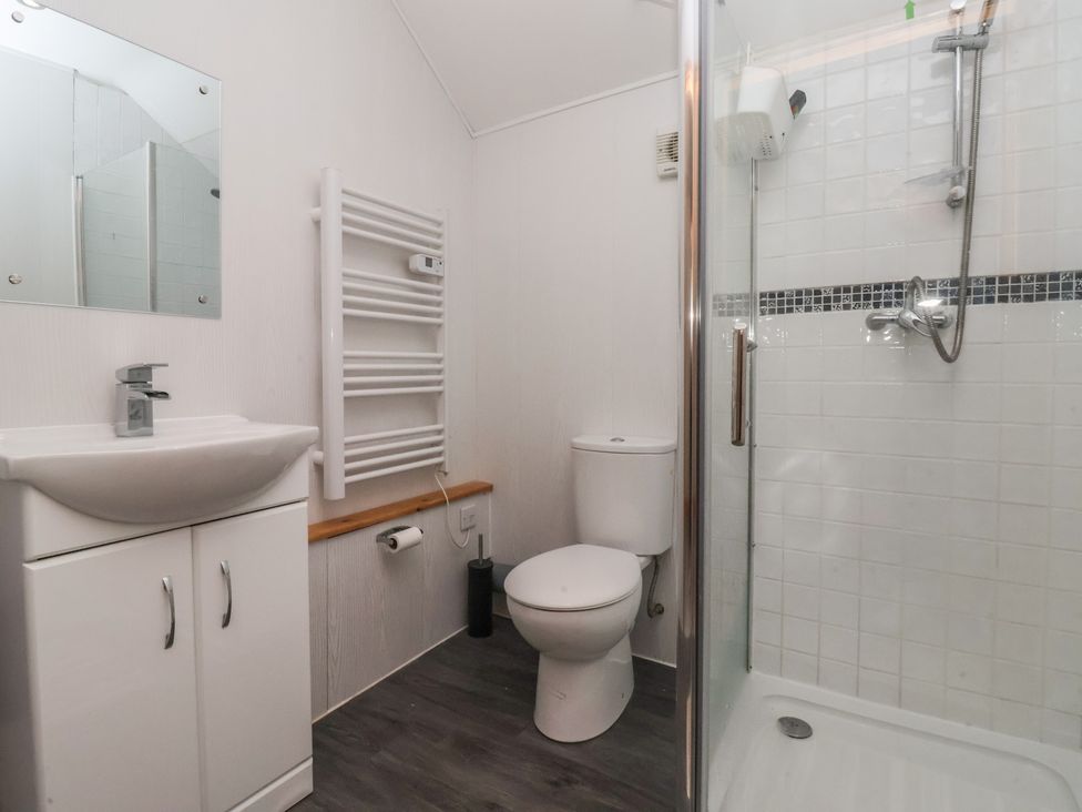 A bathroom featuring a sink and toilet at Honeybee Cottage in Withernsea