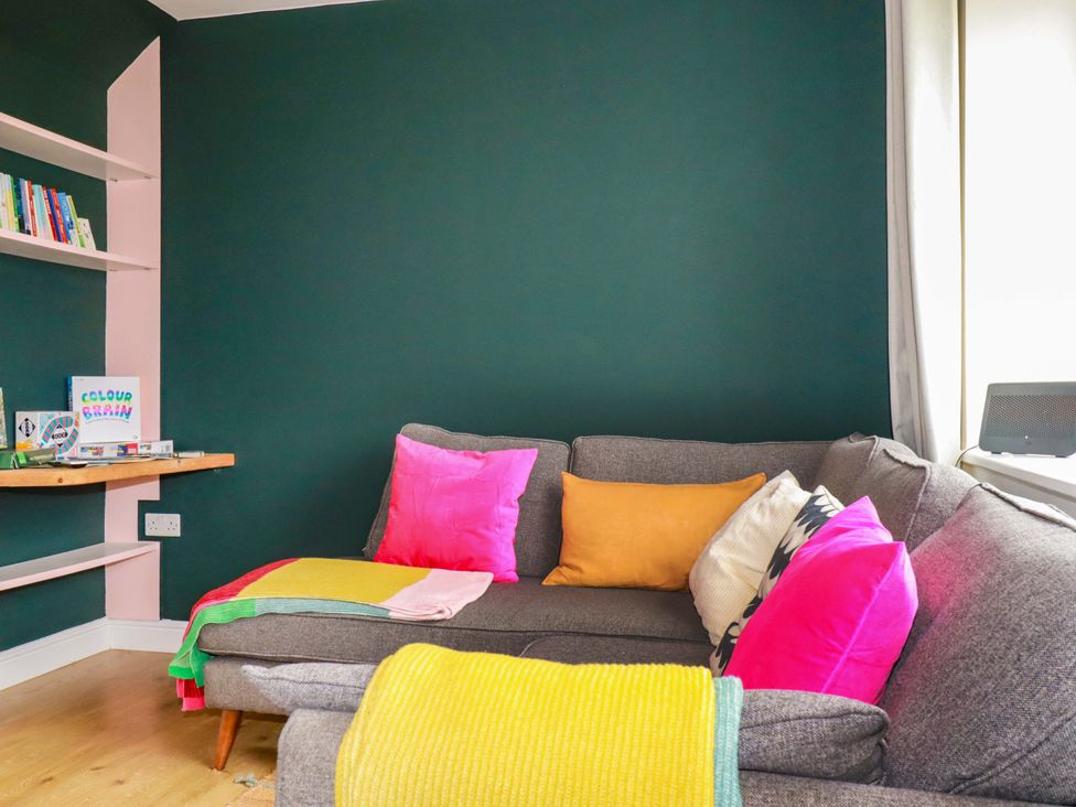 A sitting room with a sofa and shelves at Trelowen in Trenance