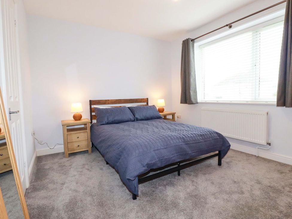 A bedroom with a bed and nightstand at Trelowen in Trenance