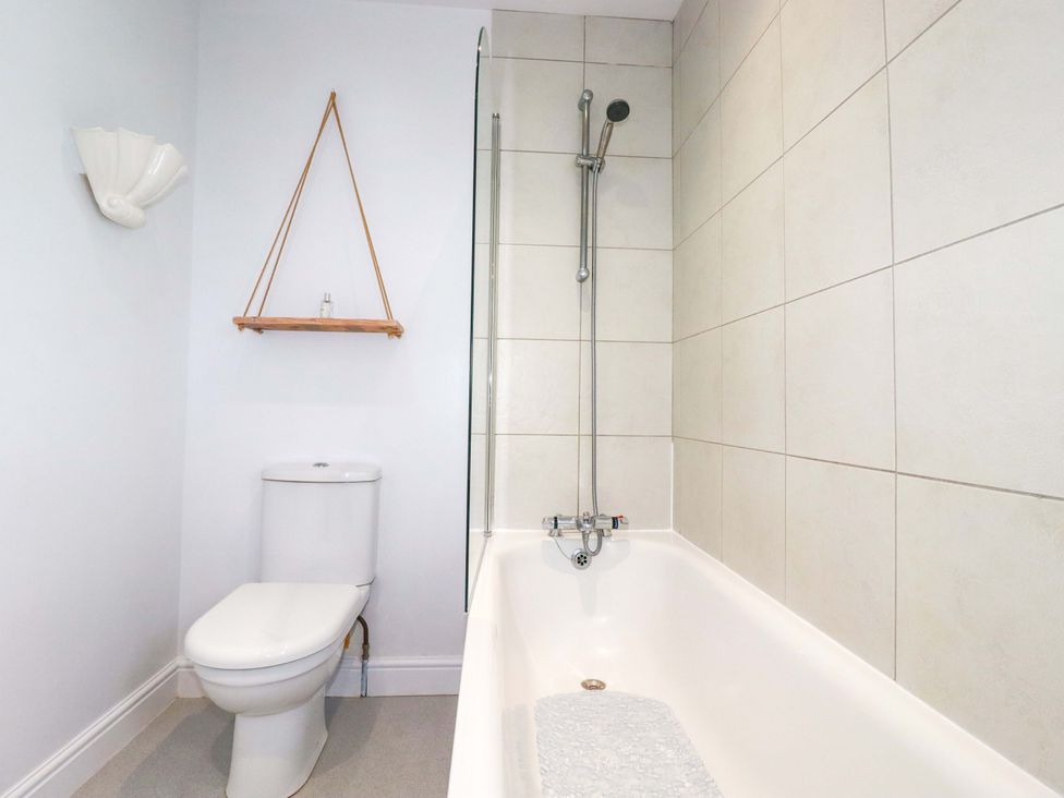 A bathroom with a bathtub, toilet, and shower at Trelowen in Trenance